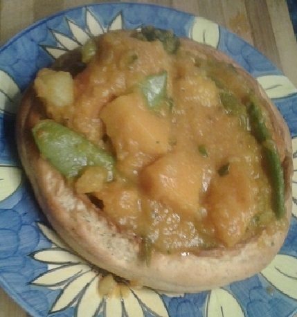 Curried vegetables in bread bowl